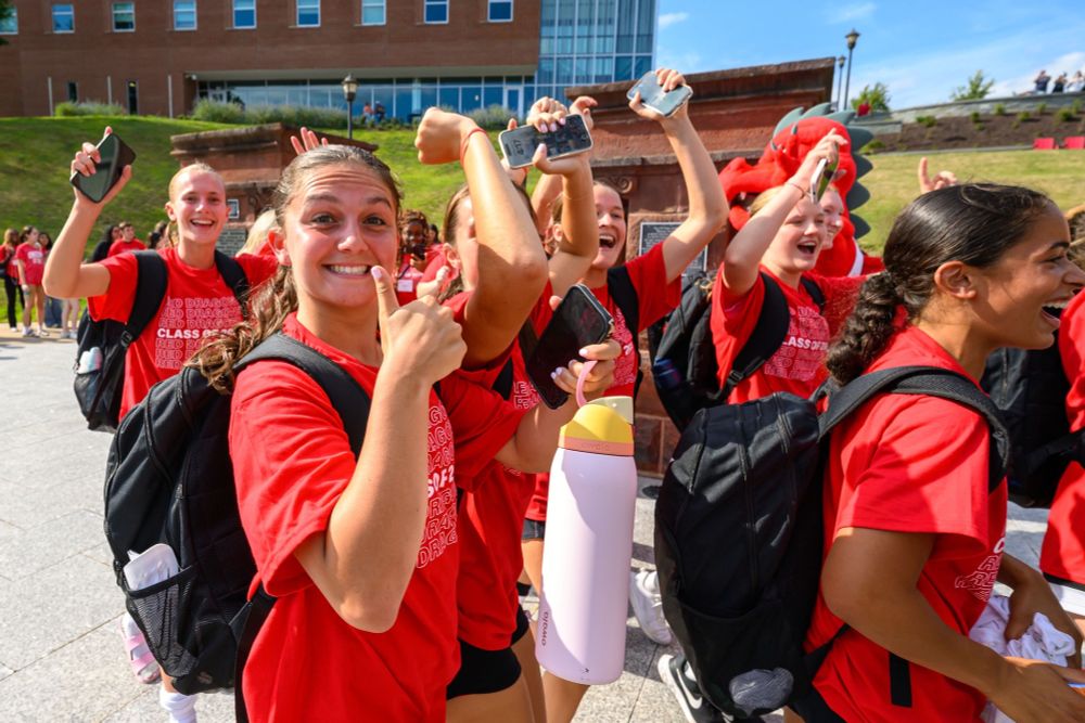 Students happily pass through the pillars on campus 