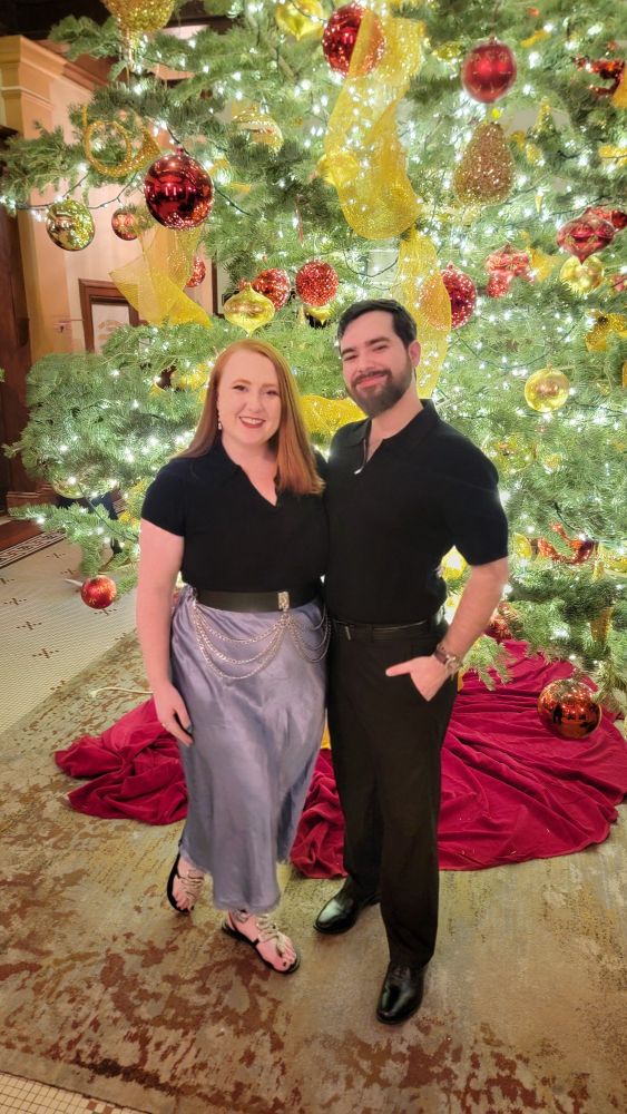 Photo of Arcane and her husband in front of a Christmas Tree! 