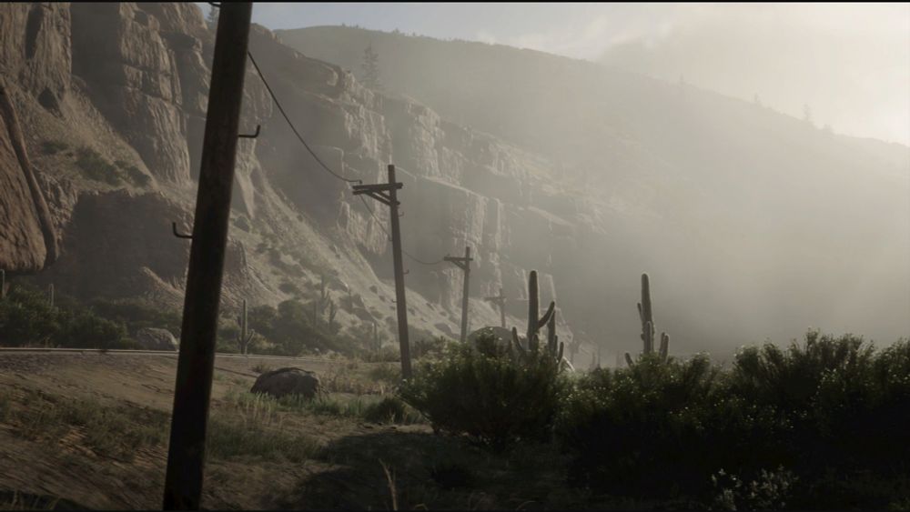 a screenshot from the game Red Dead Redemption 2, some pole lines along a railway in a dusty deserty area