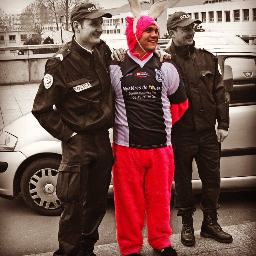 A photograph of a man in a bunny costume being arrested by the Paris Police (humour - he is probably simply posing with them for a laugh)