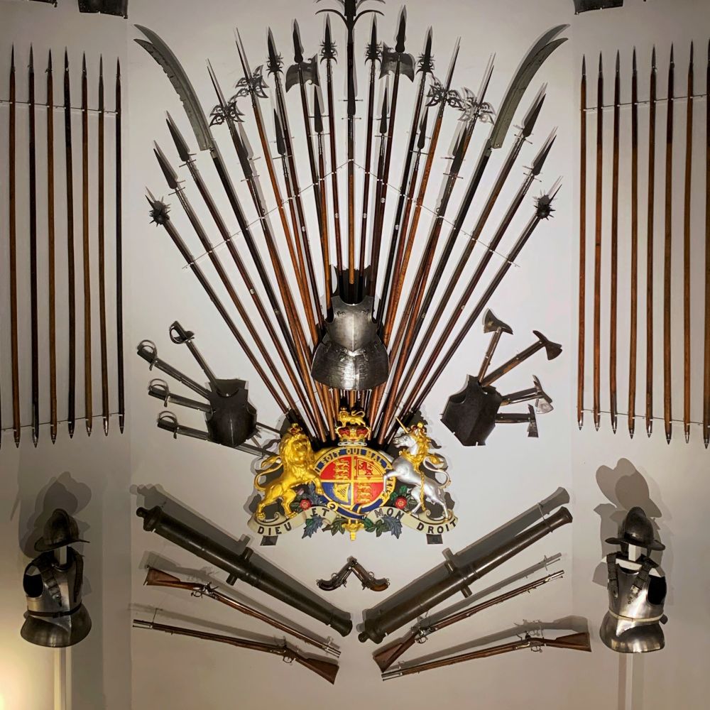 A display of various armours, guns, and swords.