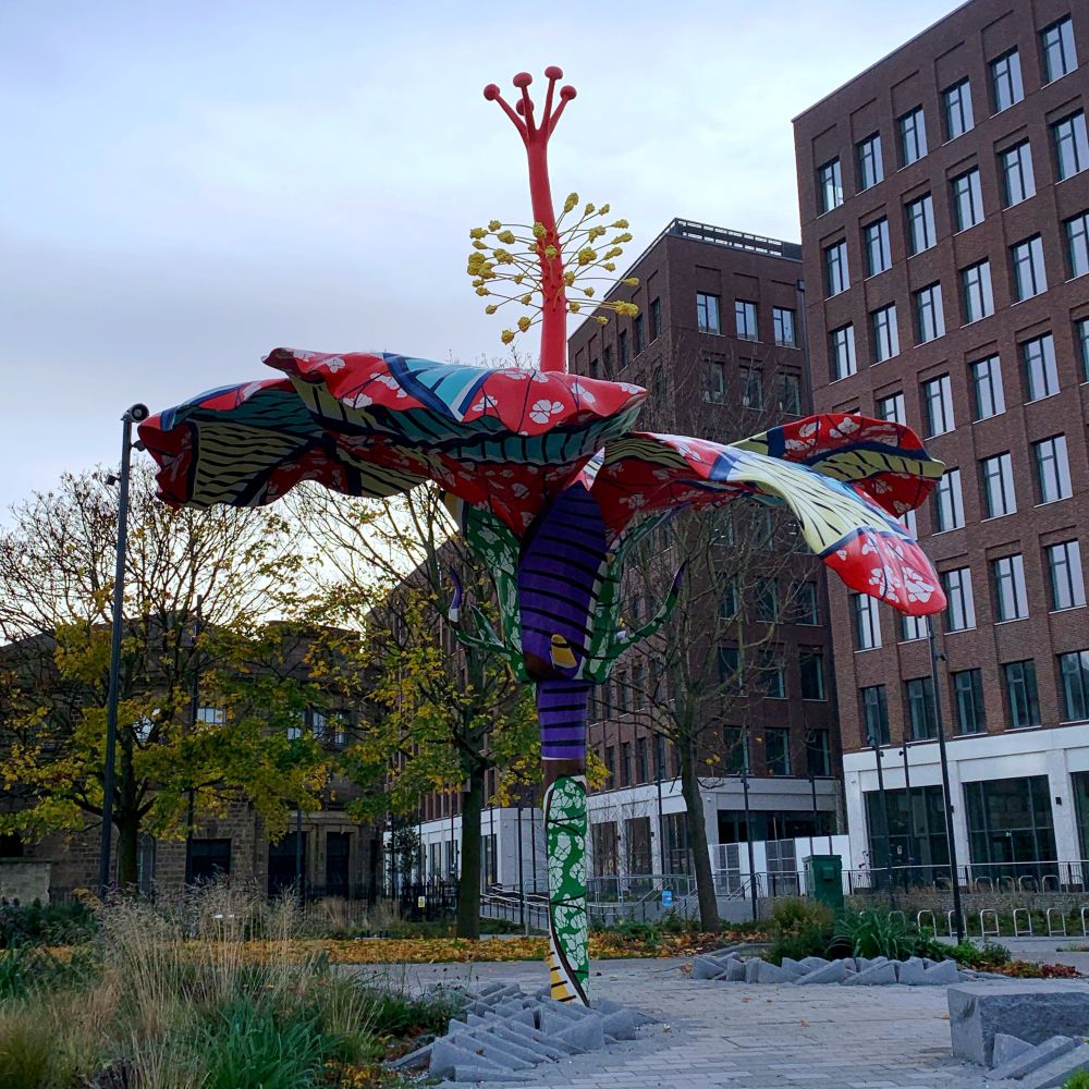 A large open air sculpture depicting a flower with various colours and patterns.
