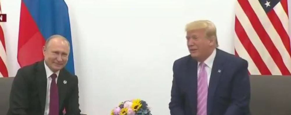 The mainstream media has bought the White House spin that Trump is holding a summit with Putin. What Trump is doing is rolling out the red carpet for a war criminal.