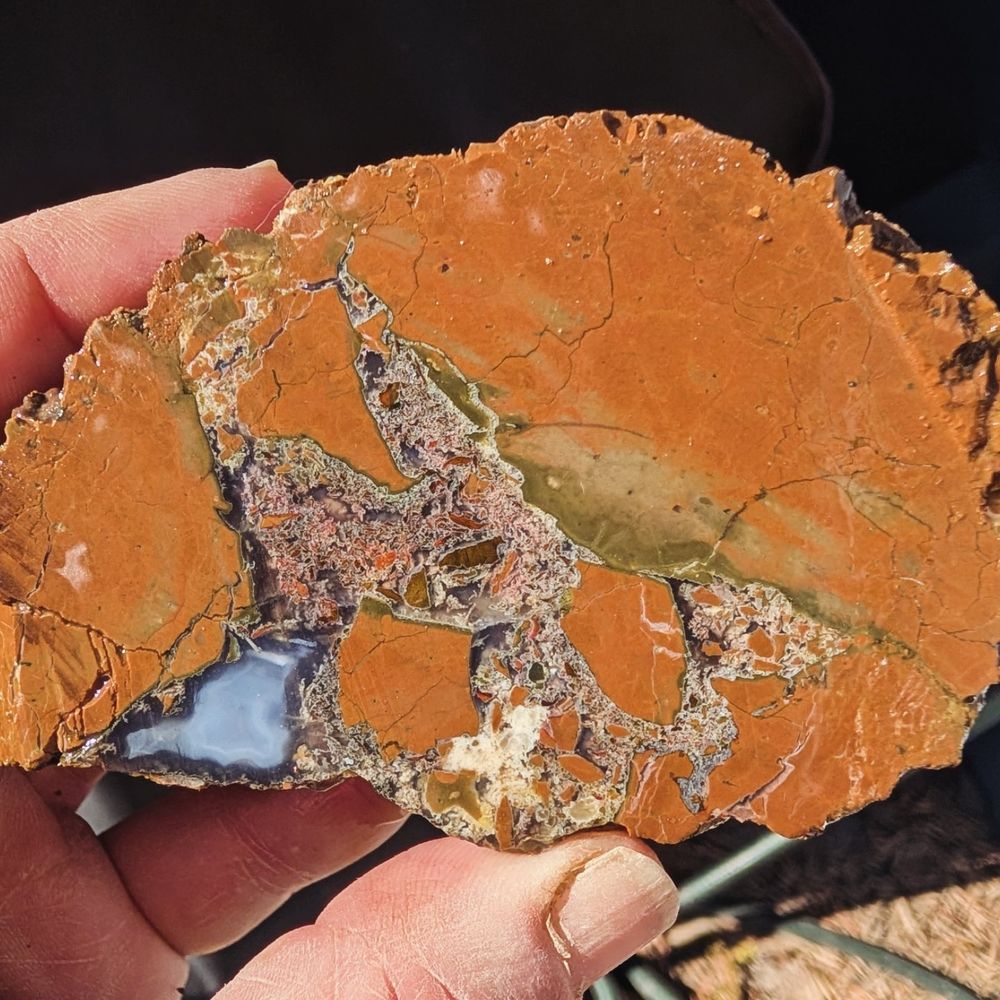 Thunder egg with white agate pocket in the lower left corner.