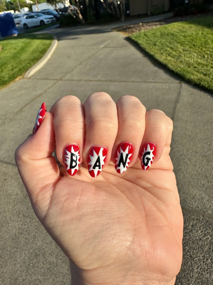 Red and white nails that say Bang in black lettering 