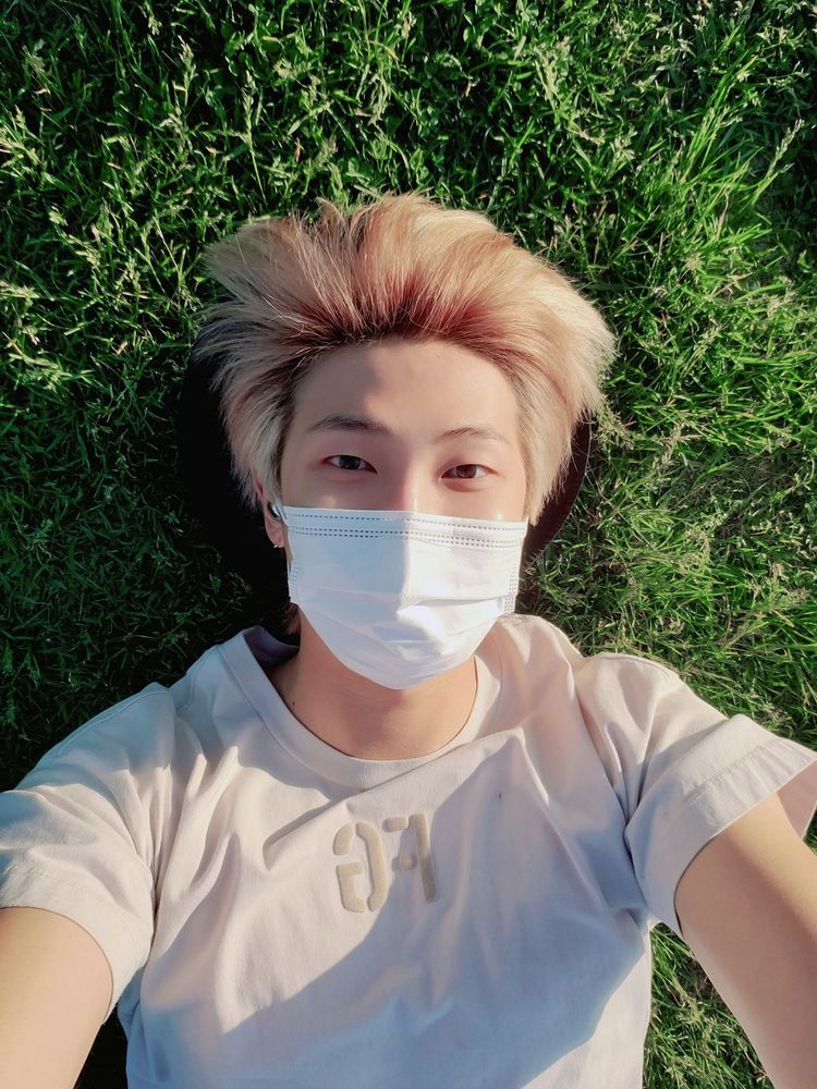 blonde namjoon laying in the grass like some sort of cutie patootie nature being