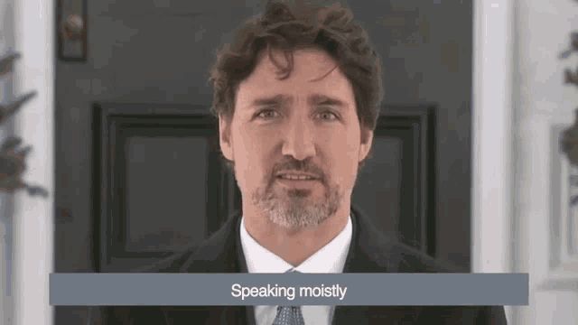 A gif of Canadian PM Justin Trudeau at a presser outside Rideau Cottage, circa March 2020, with a closed caption that reads ‘speaking moistly’
