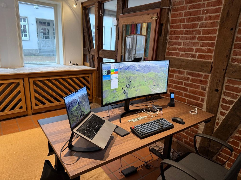 A photo of my desk with monitor, laptop, mouse and keyboard in my New Office. 
