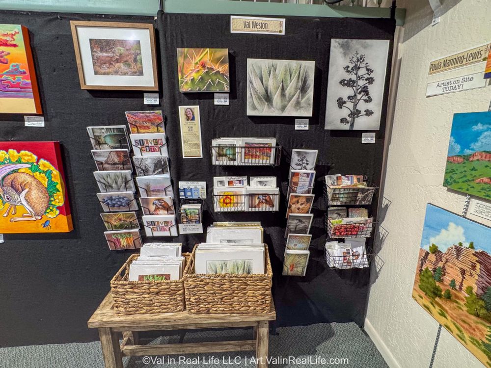 Wall art, cards, and art prints in a gallery display.