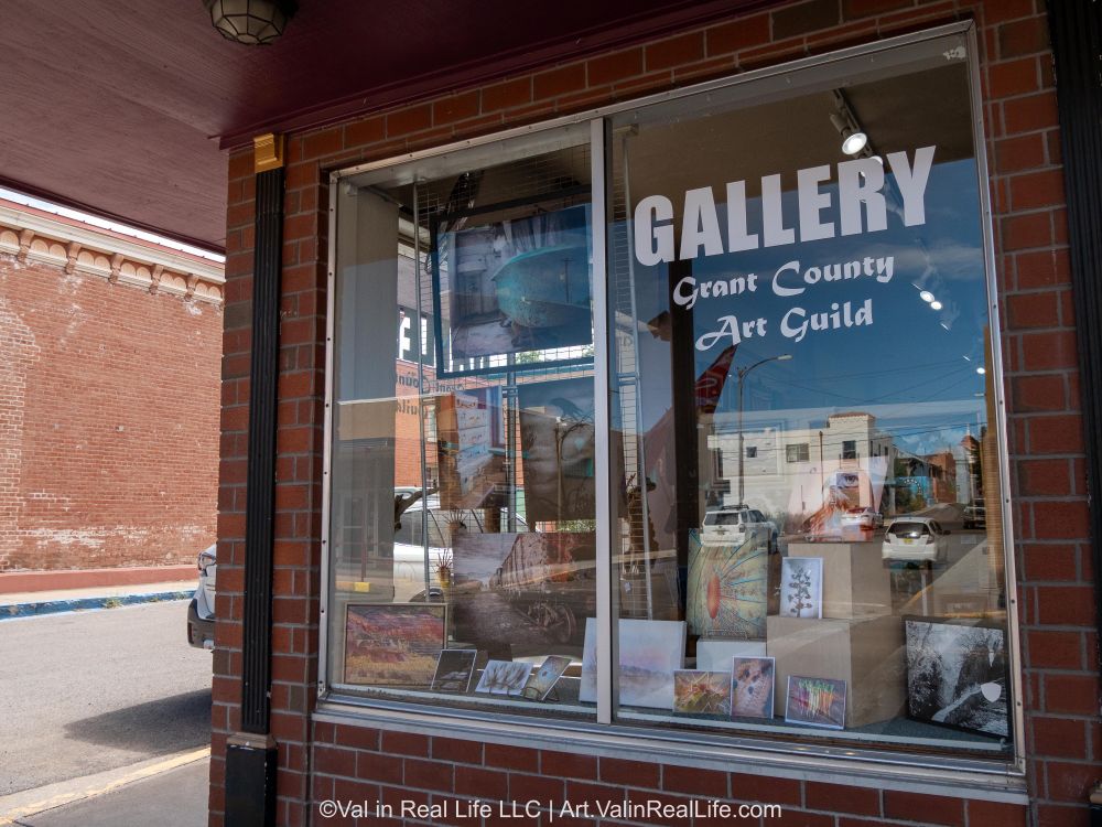 Window of the Grant County Art Guild gallery with Val Weston's artwork on display.