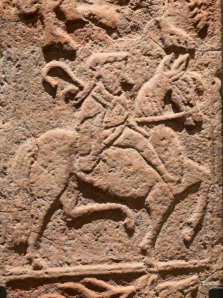 A figure on horseback carrying a crozier