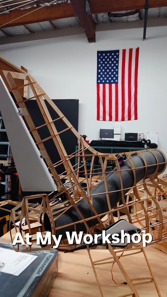 RC airplane L-1011 tail section frame in the RC CAD workshop with the American flag hanging on the wall in the background. 