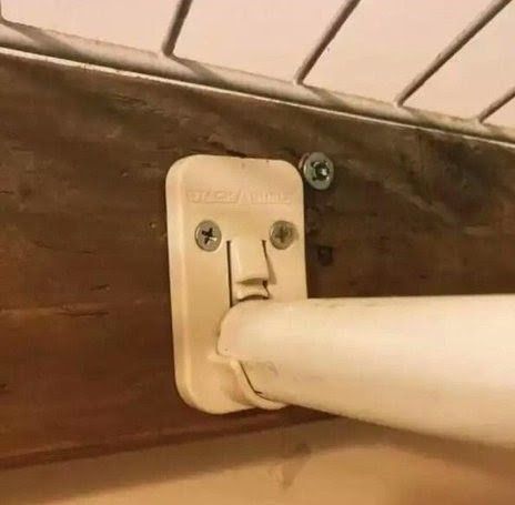 A closet pole mount and pole that somehow appears to look like a face, sword swallowing. 