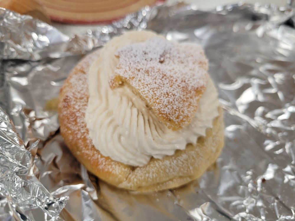 Gluten free semla bun: yeasted Swedish Easter bun filled with marzipan, topped with vanilla cream and dusted with icing sugar. 