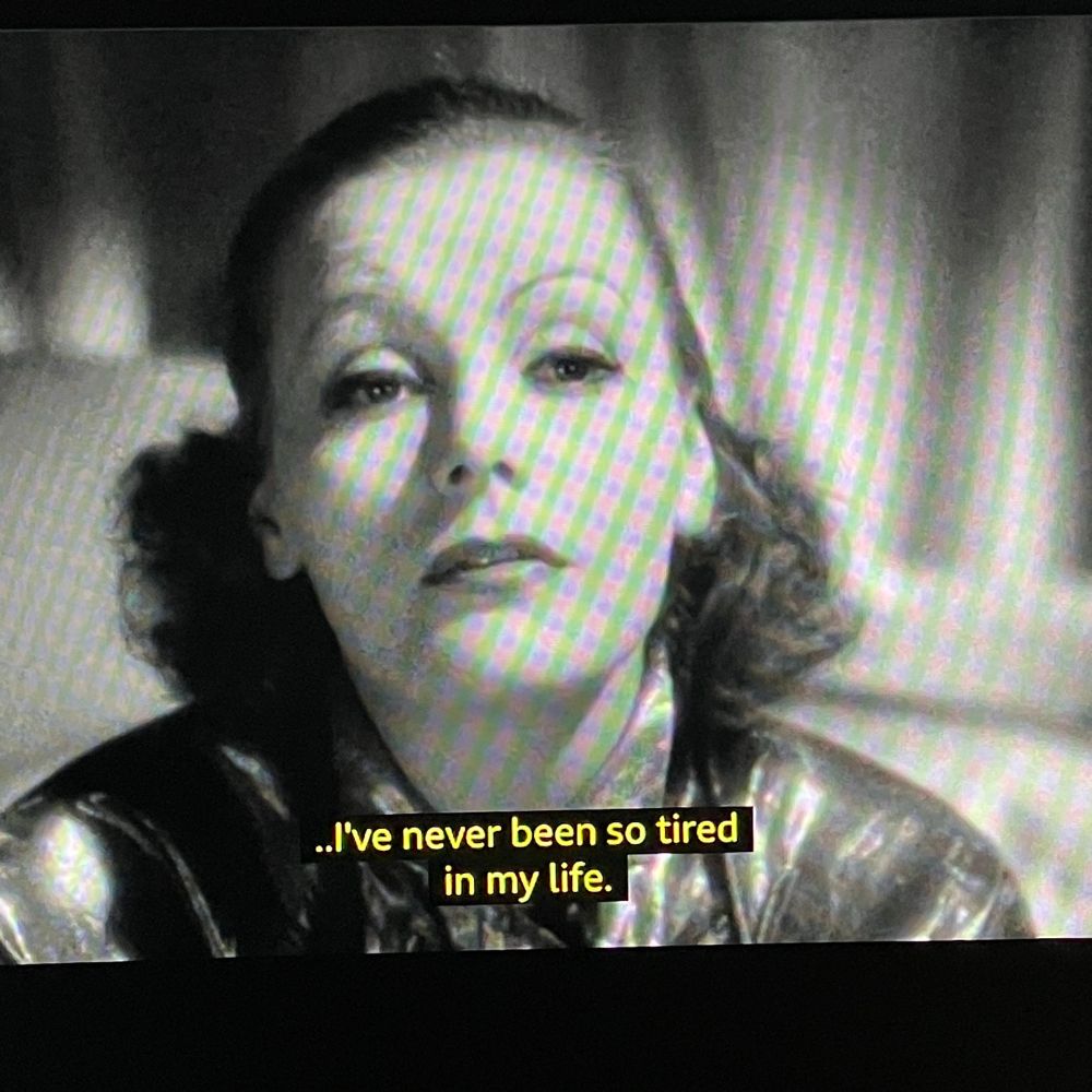Close-up of Garbo, in a negligee, with subtitle reading ‘I’ve never been so tired in my life’.