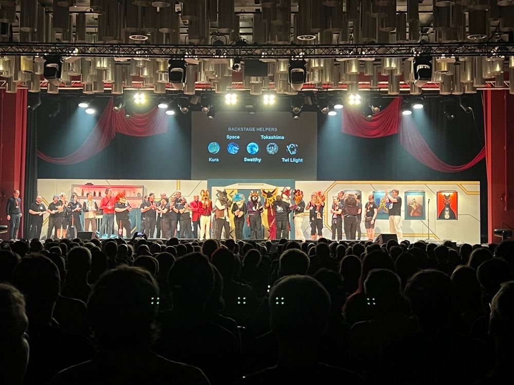 a photo of the crew of Starfall by the Furry Drama Company. there's lots of people up on stage, some in fursuits (mostly the actors).