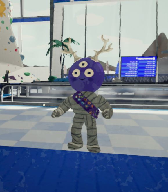 Screenshot from the game PEAK. Purple round-headed character stands smiling, three eyes on their face, bone-white antlers on their head, and wrapped in mummy tape with a sash of badges around their chest.