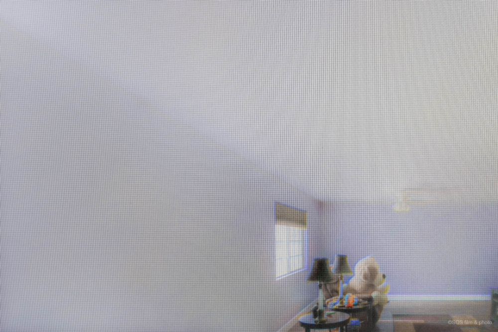 A living room with a long, sprawling wall.