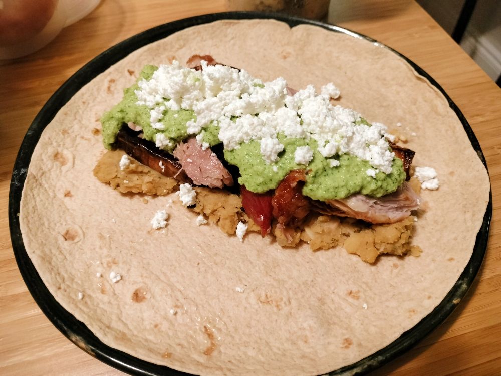 Roman burrito: wheat tortilla, refried chickpea and lentil, caramelized onion, roast pork, farmer cheese, olive salsa