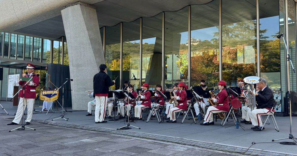 Young people in red band uniforms performing outside