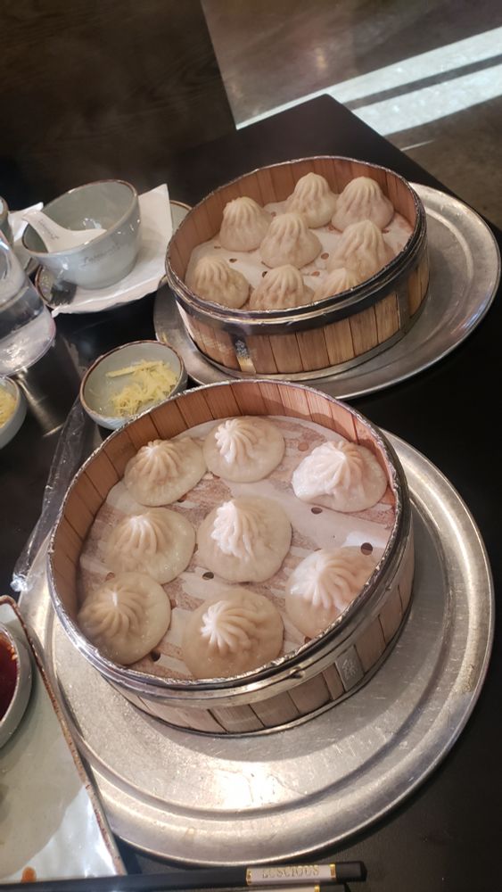 Two baskets of steamed dumplings 
