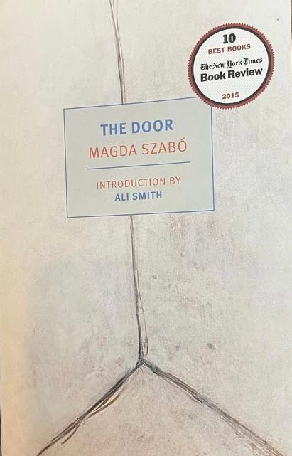 Cover of the novel the door by Magda Szabo.  A light gray background with three straight lines forming a corner. That’s it.