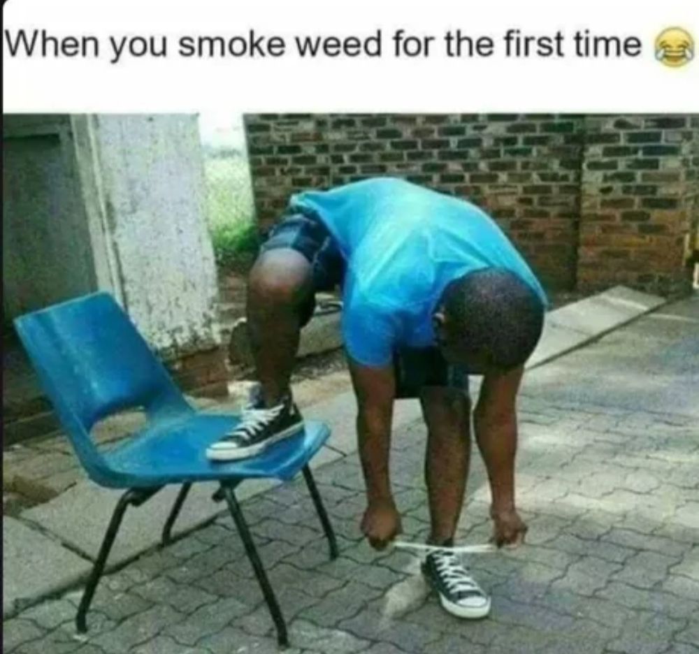 A person in a blue shirt is standing next to a blue chair, they are bending over and has one foot on the chair and one foot on the ground. They are tying the shoe on the ground, not the one on the chair.
Caption: When you smoke weed for the first time 🤣😂