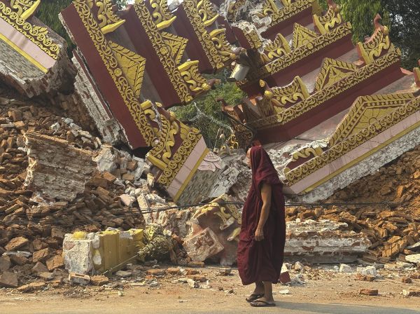A Buddhist monk walking near a collapsed pagoda after an earthquake in Mandalay, central Burma (Myanmar), on March 30. 