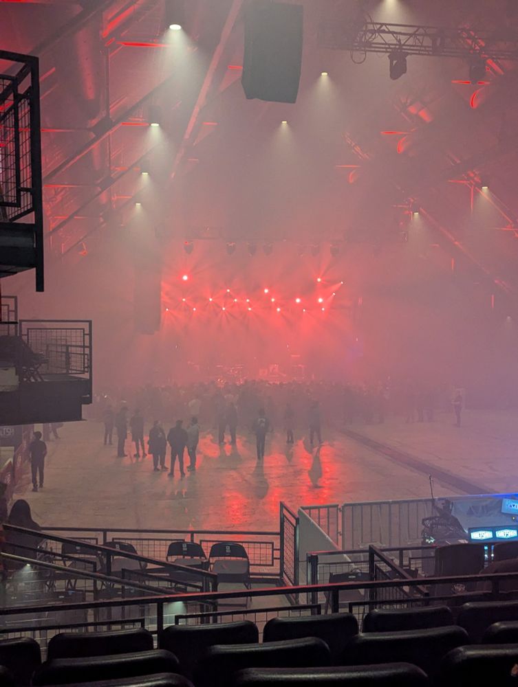 Main floor of the Salt Shed in Chicago, obscured by smoke and lit in red.