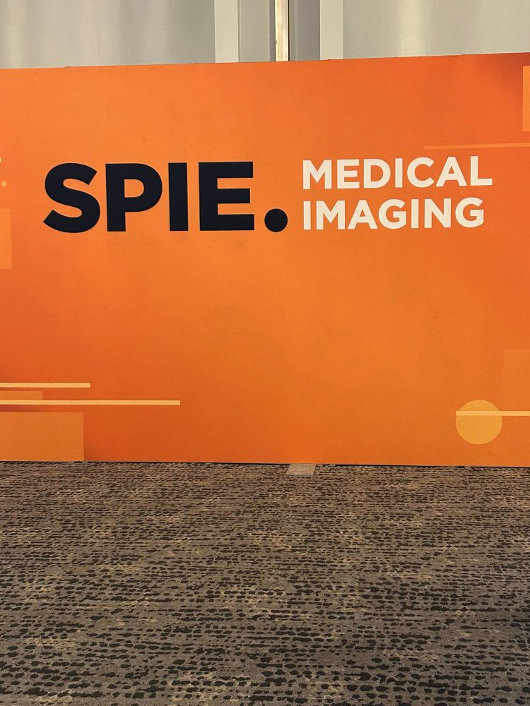 An orange wall saying “SPIE Medical Imaging”