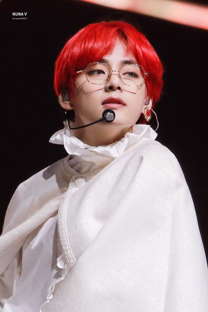 Kim Taehyung with a white cape and red hair and a red earring 