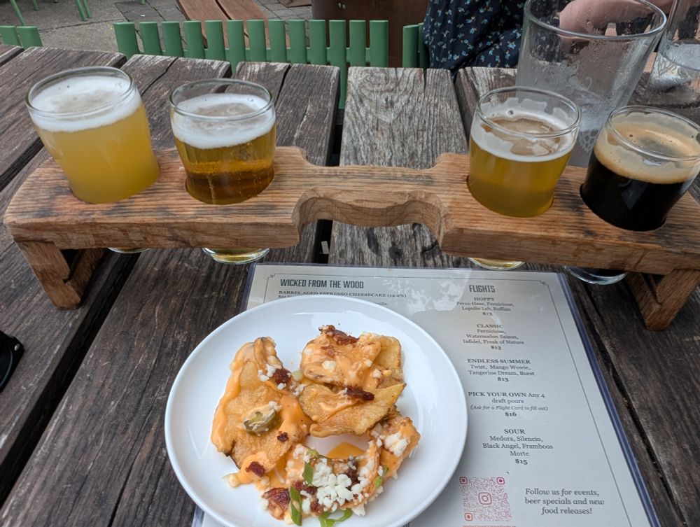 Wicked Weed flight. Left to right: Perni-haze, Pernicious [their flagship IPA], Lupulin Lab, Ruffian. All are excellent. Loaded chips split 4 ways joins the flight - one each for my partner & me.