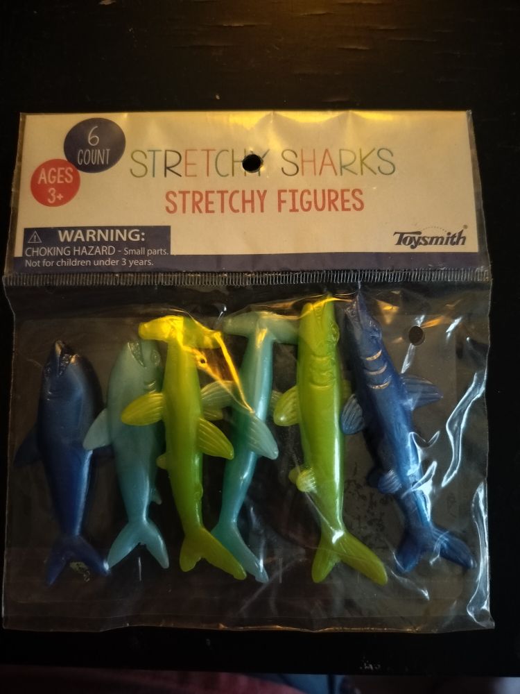 Package of green and blue stretchy sharks