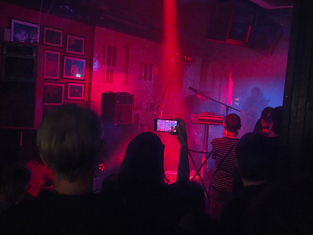 Bdrmm at the 100 Club - pink lights over a small crowd 