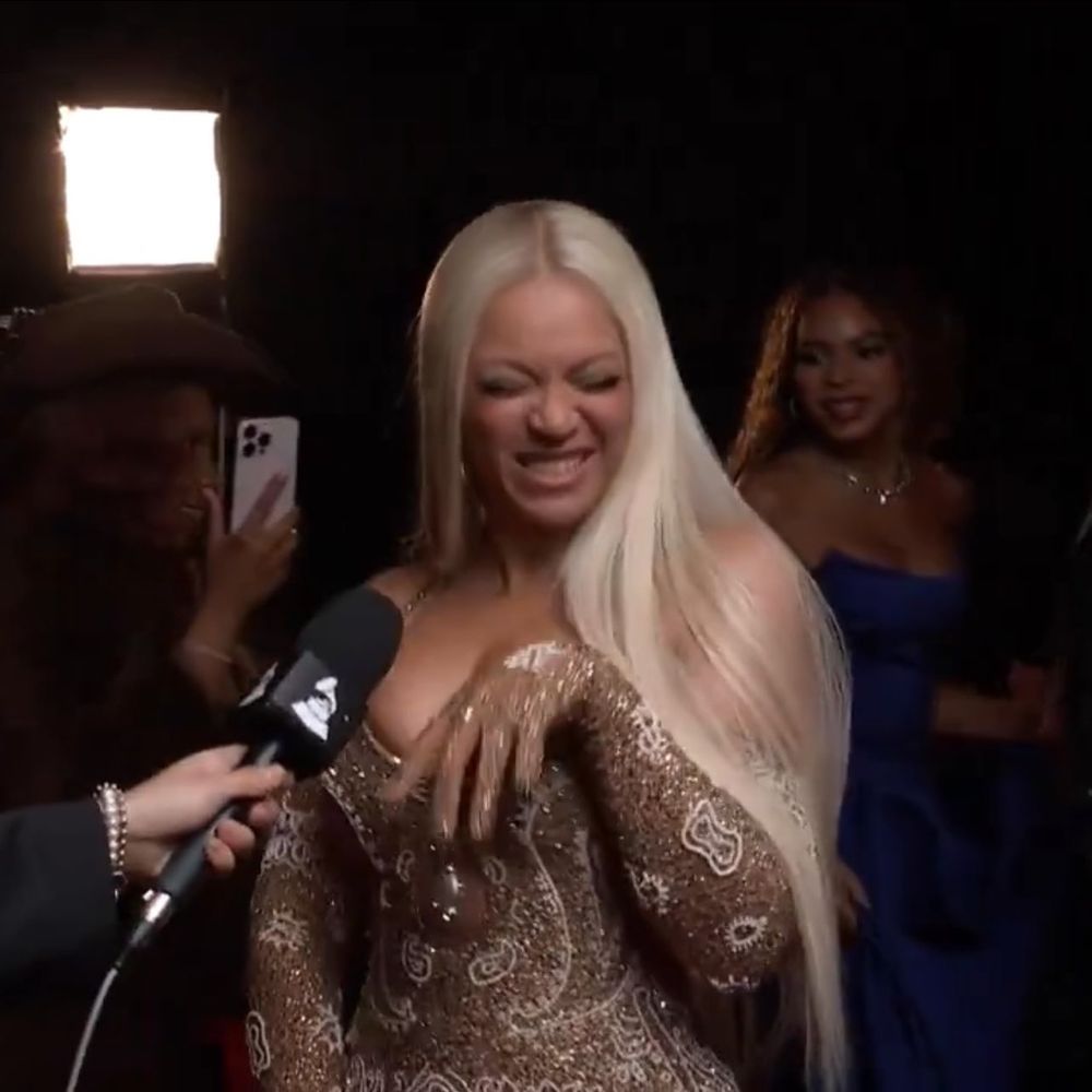Beyonce being gorgeous and cute backstage at the Grammys, flopping her wrist in a feminine manner while closing her eyes and grinning. 