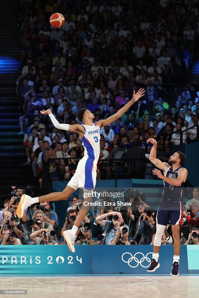Steph Curry drilling a 3 over Victor Wembanyama's like 8-foot wingspan 