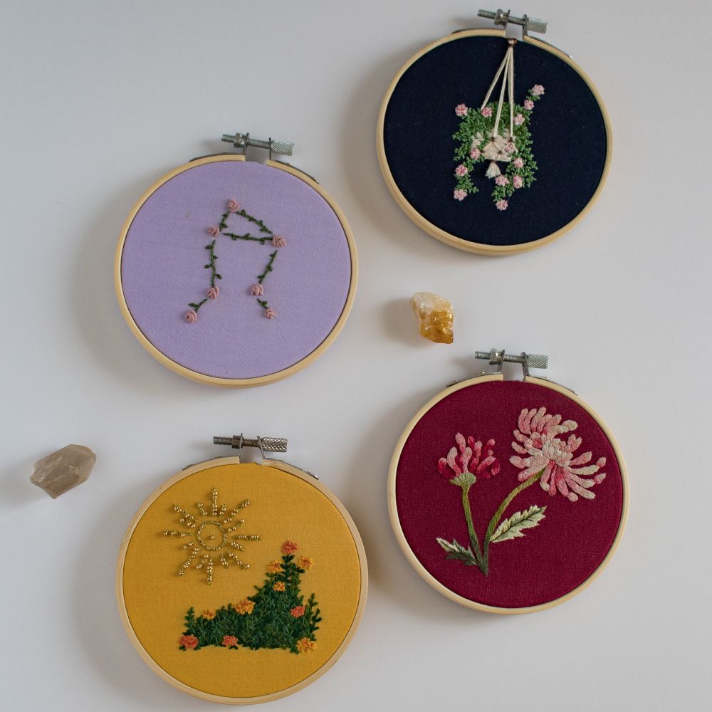 Four embroideries featuring flowers associated with the signs of Leo, Virgo, Scorpio, and Libra.