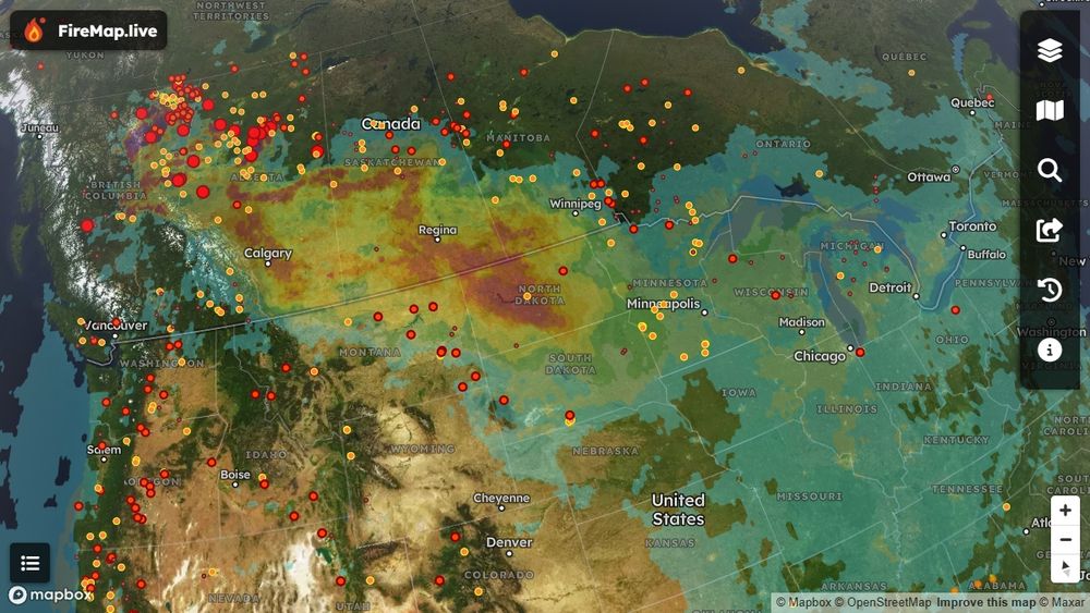 Satellite imagery showing dense wildfire smoke covering southern Canada, particularly heavy over Saskatchewan and Manitoba, extending down into North Dakota. Lighter smoke is visible stretching eastward, reaching cities like Calgary, Edmonton, Toronto, and Chicago. Data from FireMap’s hourly smoke monitoring.