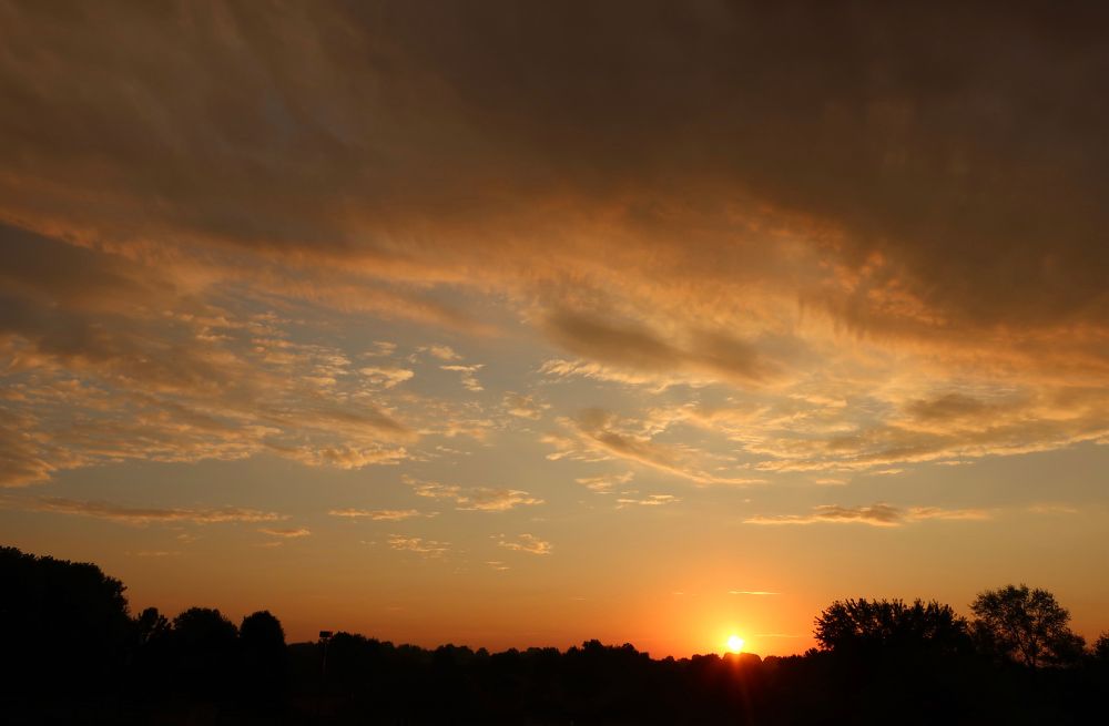 Sunrise in a partially cloudy sky