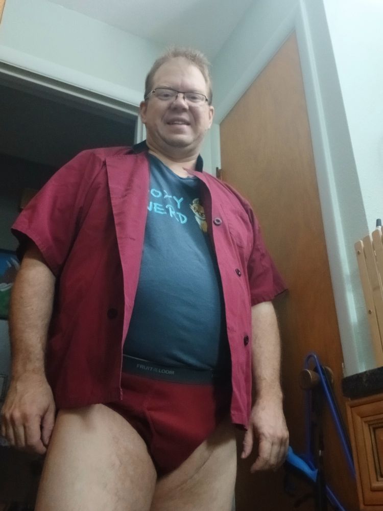 Freefox in a maroon chef coat and briefs with a t shirt that says foxy nerd tucked into the briefs