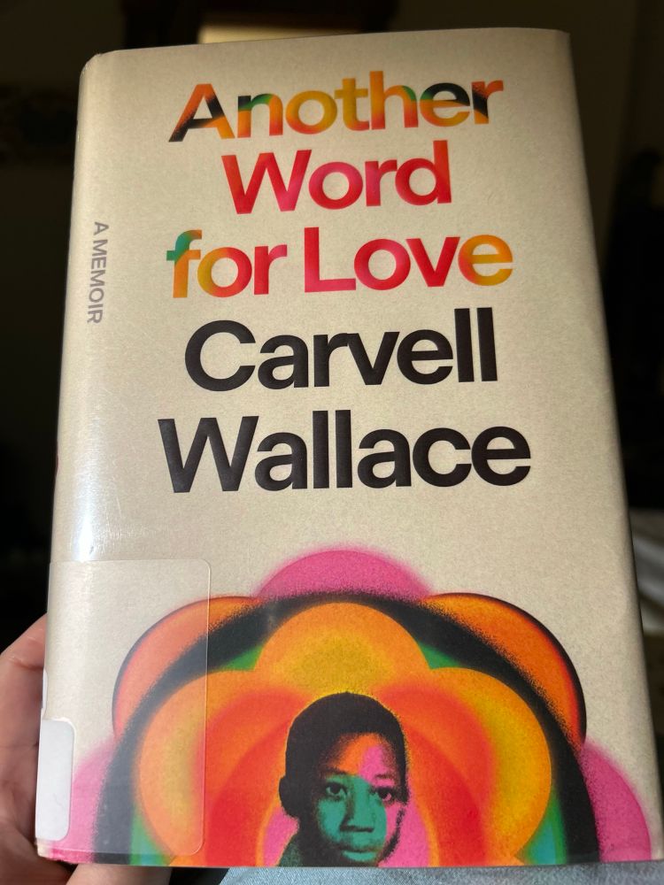 Image of book cover with picture of a young Black boy’s head surrounded by bright orange, pink, yellow, and green flower-like abstract shape.