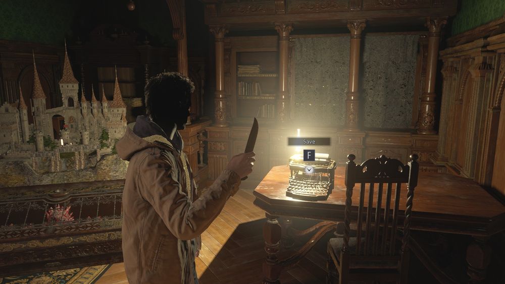 RE8 screenshot inside the castle, in the save room. Ethan is holding a pocket knife, standing by the typewriter and the castle ball puzzle thing. but his face/hair has been covered in darkness to hide his identity