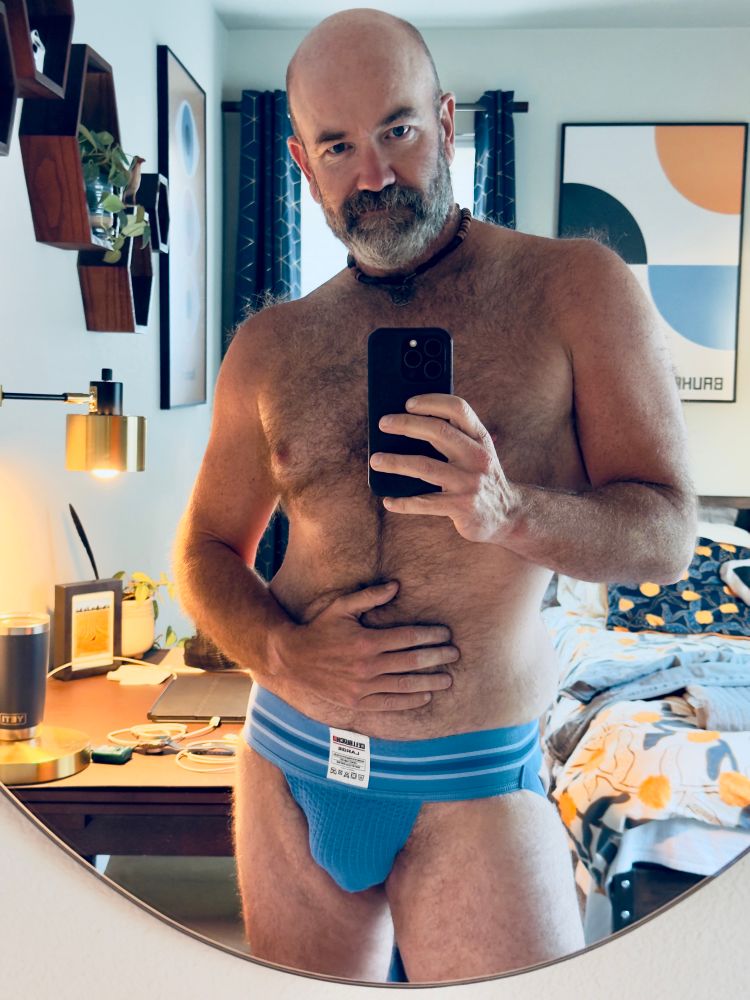 Man in light blue jock strap