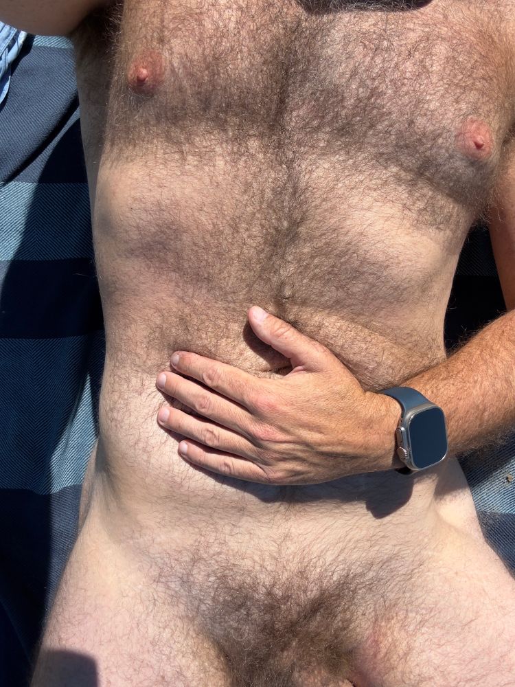 hairy male torso on a beach blanket