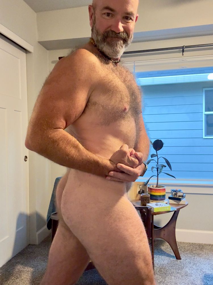 Naked man flexing and twisting and smirking. 