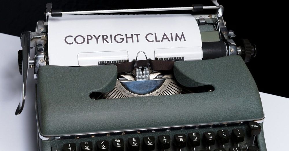 The phrase "COPYRIGHT CLAIM" appears at the top of a piece of paper in a typewriter.