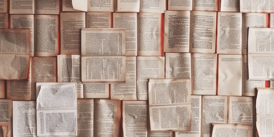 Open books are spread across a surface.