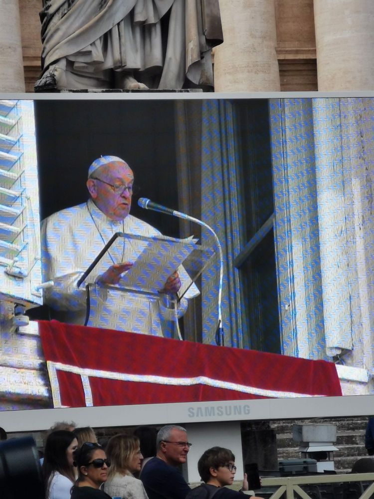 Large screen of video of Pope Francis giving address from window of apartment in Vatican City 