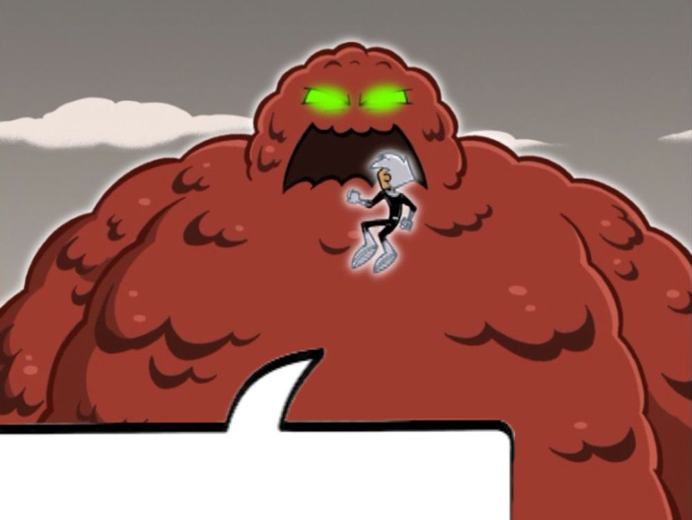 danny phantom floating in front of a giant blob of meat with glowing green eyes
