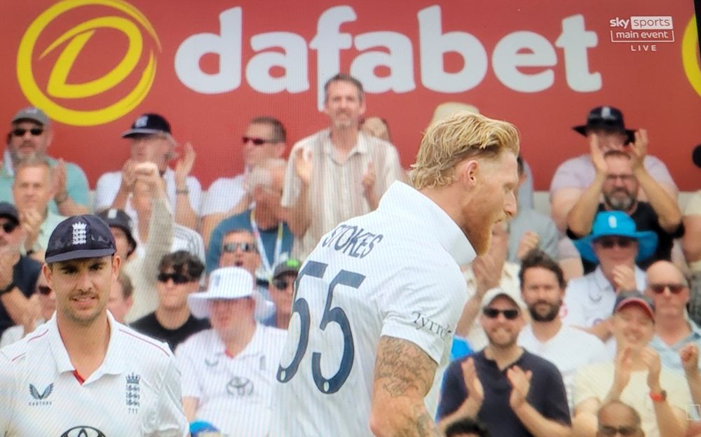 England cricket captain Ben Stokes walking in front of an advertisement for bookmaker Dafabet, which is illegal in India.